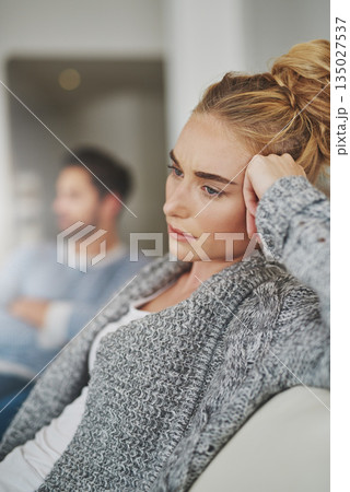 Sad, depression and woman in conflict with her boyfriend in the living room of their apartment. Upset, disappointed and moody female person in argument, fight or breakup with partner at their home. 135027537