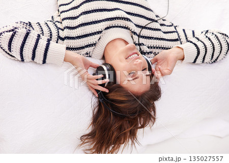 Relax, music and happy woman on bed with headphones from above, happiness and wellness in home. Audio, smile and girl in bedroom listening to streaming radio service or podcast with peace and freedom Relax, music and happy woman on bed with headphones from above, happiness and wellness in home. Audio, smile and girl in bedroom listening to streaming radio service or podcast with peace and freedom 135027557