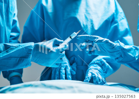Surgery, operating room and hands of doctor with needle for healthcare, teamwork and professional medicine. Medical innovation, syringe and surgeon with expert staff in hospital icu for operation. Surgery, operating room and hands of doctor with needle for healthcare, teamwork and professional medicine. Medical innovation, syringe and surgeon with expert staff in hospital icu for operation. 135027563