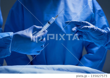 Surgery, teamwork and hands of doctor with needle for healthcare, tools and focus on professional medicine. Medical innovation, operating room and surgeon with expert staff in hospital operation. Surgery, teamwork and hands of doctor with needle for healthcare, tools and focus on professional medicine. Medical innovation, operating room and surgeon with expert staff in hospital operation. 135027573