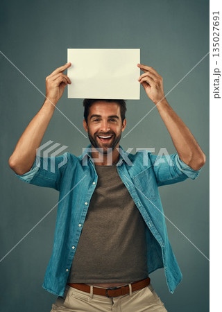 Happy man, portrait and mockup billboard for advertising, marketing or branding against a grey studio background. Male person holding rectangle poster, placard or board for sign or advertisement 135027691