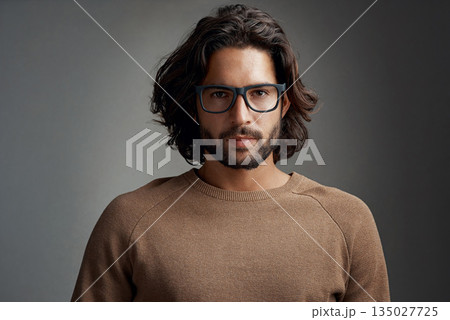 Portrait, glasses and serious man in studio isolated on a gray background. Face, nerd and handsome male person from Australia with spectacles, eyewear or frames for fashion, stylish and aesthetic. 135027725