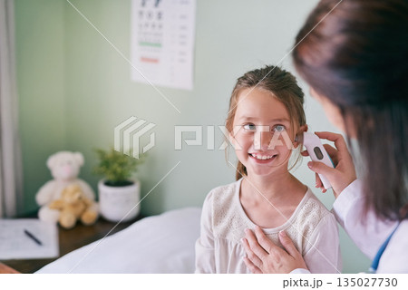 Healthcare, kids and a girl at the pediatrician for an ear exam, appointment or checkup in the hospital. Medical, happy and temperature with an adorable female child sitting on a bed in the clinic Healthcare, kids and a girl at the pediatrician for an ear exam, appointment or checkup in the hospital. Medical, happy and temperature with an adorable female child sitting on a bed in the clinic 135027730