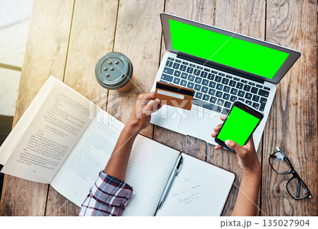Woman, hands and credit card on technology with green screen in ecommerce, payment or purchase above at cafe. Top view of female person hand holding phone and laptop mockup display in online shopping 135027904