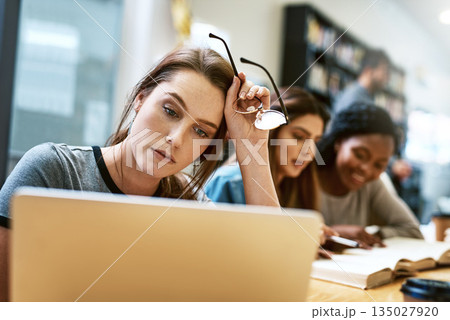 Woman, stress and laptop for studying at library, college or campus with tired face, anxiety or burnout. University student, girl and computer for education, study and fatigue at school with reading Woman, stress and laptop for studying at library, college or campus with tired face, anxiety or burnout. University student, girl and computer for education, study and fatigue at school with reading 135027920