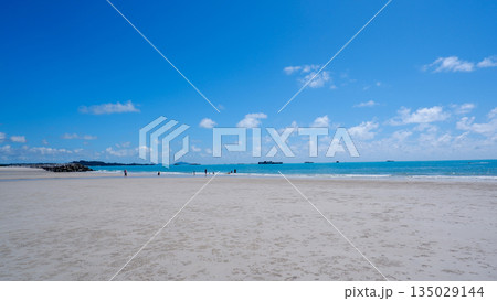 Beautiful White Sand Shoreline of Sungailiat Beach with Blue Sky and People Relaxing Beautiful White Sand Shoreline of Sungailiat Beach with Blue Sky and People Relaxing 135029144