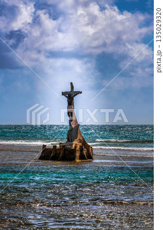 The statue of The Black Christ rises from the surf off the shore of Big island or Isla Grande near Portobelo, Panama. The statue of The Black Christ rises from the surf off the shore of Big island or Isla Grande near Portobelo, Panama. 135029320