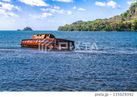old rusty shipwreck at the shores of Isla Grande near Portobelo in Panama old rusty shipwreck at the shores of Isla Grande near Portobelo in Panama 135029392