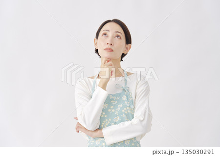 エプロンを着た女性 考える 白背景 エプロンを着た女性 考える 白背景 135030291