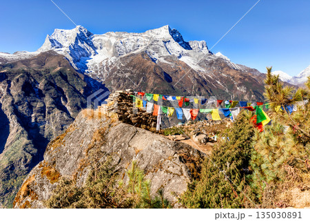View at the prayers flags and Kongde Ri peak on the trek to Everest base camp, Nepal. View at the prayers flags and Kongde Ri peak on the trek to Everest base camp, Nepal. 135030891