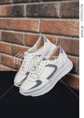 Fresh beige leather sneakers without brand marks displayed. For design templates online shops and sustainability-themed marketing. Clean blank sneakers 135031156
