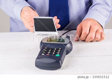 Man using smartphone to express pay 135031512