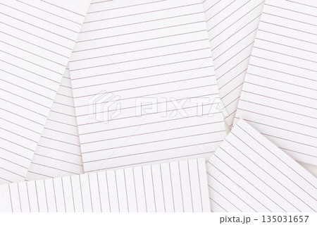 Lined paper strewn over surface 135031657