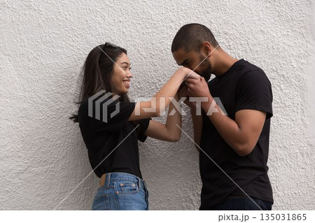 Flat design couple are leaning against stucco wall, man is kissing woman's hand with sunglasses Flat design couple are leaning against stucco wall, man is kissing woman's hand with sunglasses 135031865