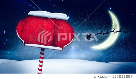 Showing flat design snowy scene with blank red signboard on candy cane pole, moon, Santa sleigh Showing flat design snowy scene with blank red signboard on candy cane pole, moon, Santa sleigh 135031897
