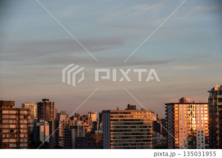Sunlight falling on buildings during sunset Sunlight falling on buildings during sunset 135031955