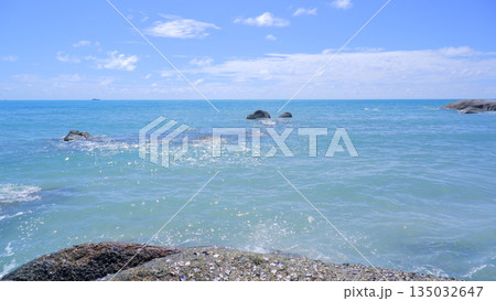 Sunlight Reflecting on Crystal Clear Sea Water with Granite Rocks 135032647