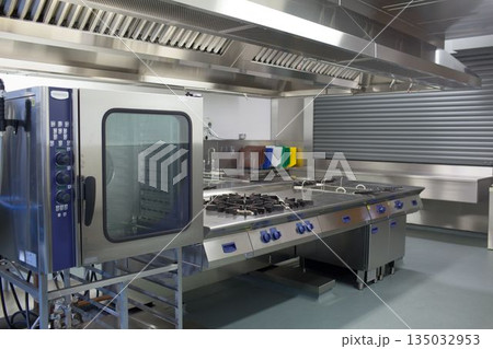 Stainless steel appliances in commercial kitchen Stainless steel appliances in commercial kitchen 135032953