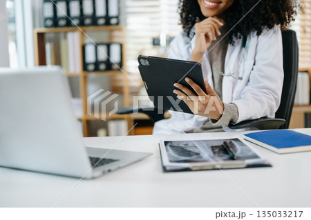 Medical technology concept. Doctor working with mobile phone and stethoscope and digital tablet laptop Medical technology concept. Doctor working with mobile phone and stethoscope and digital tablet laptop 135033217
