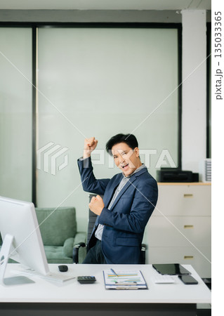 Young attractive Asian male office worker business suits smiling at camera 135033365