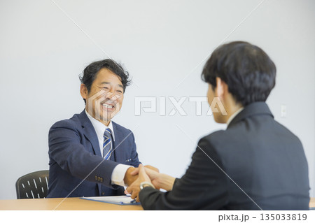 笑顔で話を聞くビジネスマン 笑顔で話を聞くビジネスマン 135033819