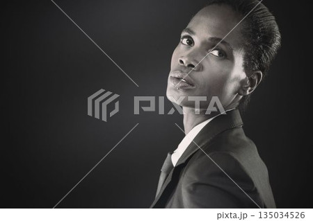 Thoughtful businesswoman against black background Thoughtful businesswoman against black background 135034526