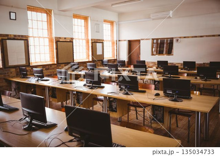 Flat design computer classroom is showing wooden desks with monitors, keyboards and sash windows 135034733
