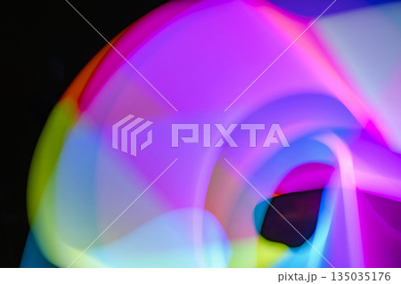 Abstract image of light painting with blur effect. Colorful vibrant lights are swirling in the dark background. It can be used as wallpaper, background or design element 135035176