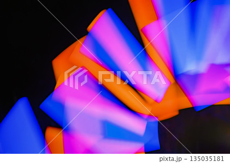 Abstract image of light painting with blur effect. Colorful vibrant lights are swirling in the dark background. It can be used as wallpaper, background or design element Abstract image of light painting with blur effect. Colorful vibrant lights are swirling in the dark background. It can be used as wallpaper, background or design element 135035181