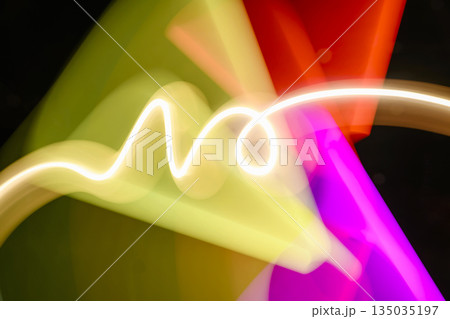 Abstract image of light painting with blur effect. Colorful vibrant lights are swirling in the dark background. It can be used as wallpaper, background or design element Abstract image of light painting with blur effect. Colorful vibrant lights are swirling in the dark background. It can be used as wallpaper, background or design element 135035197