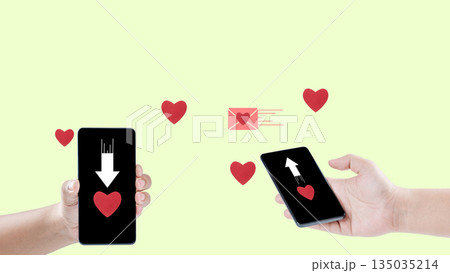 Two hands are holding smartphones and sending messages of love to each other via the internet, illustrated by hearts and an envelope. Concept of Long Distance Relationship 135035214