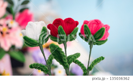 Handmade artificial rose flowers made from colorful fuzzy pipe cleaners or chenille stems. Red, pink and white DIY craft gift for Valentine's Day or Mother's Day love concept. Handmade artificial rose flowers made from colorful fuzzy pipe cleaners or chenille stems. Red, pink and white DIY craft gift for Valentine's Day or Mother's Day love concept. 135036362