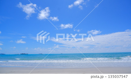 Tropical Ocean Horizon with White Waves and Blue Cloudy Sky 135037547