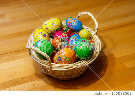 Basket with Easter eggs on wooden table Basket with Easter eggs on wooden table 135038502