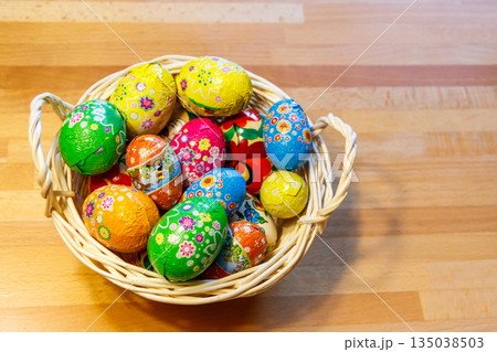 Basket with Easter eggs on wooden table Basket with Easter eggs on wooden table 135038503