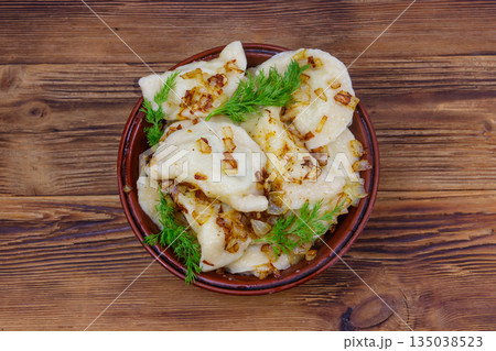 Delicious homemade dumplings on a wooden table Delicious homemade dumplings on a wooden table 135038523