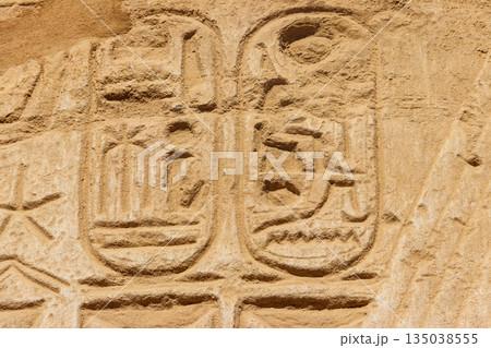 Ancient egyptian hieroglyphs on the wall in Karnak Temple Complex in Luxor, Egypt Ancient egyptian hieroglyphs on the wall in Karnak Temple Complex in Luxor, Egypt 135038555