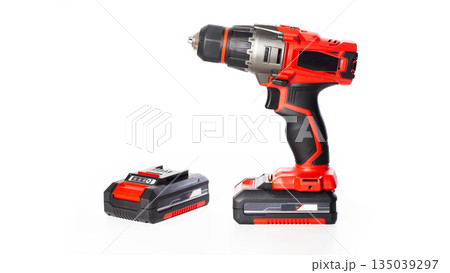 Red modern drill screwdriver with additional battery on white background, isolate. Working tool Red modern drill screwdriver with additional battery on white background, isolate. Working tool 135039297