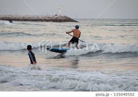 Young surfer and child. Young surfer and child. 135040502