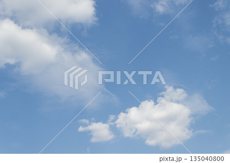 White clouds drifting across a vibrant blue sky on a sunny day White clouds drifting across a vibrant blue sky on a sunny day 135040800