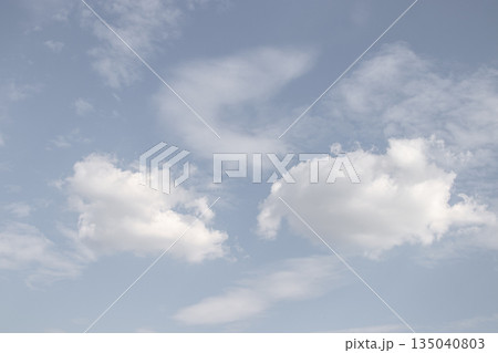 White clouds drifting across a serene blue sky White clouds drifting across a serene blue sky 135040803