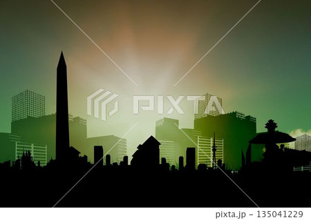 Silhouetted skyline is forming horizon with obelisk and grid-laced towers under glowing dawn sky 135041229