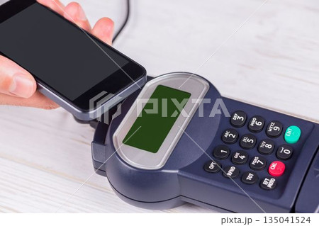 Man using smartphone to express pay 135041524