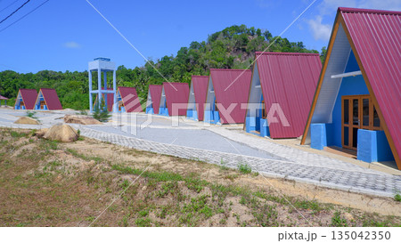 Row of Modern Blue A-Frame Cottages in Tropical Resort Row of Modern Blue A-Frame Cottages in Tropical Resort 135042350
