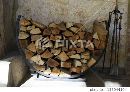 Stacked Chopped Firewood Logs in Outdoor Storage Shelter 135044104