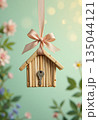 Romantic home ownership concept with miniature house and spring flowers 135044121