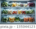 Frozen vegetables stored in freezer shelves for winter food preservation 135044123