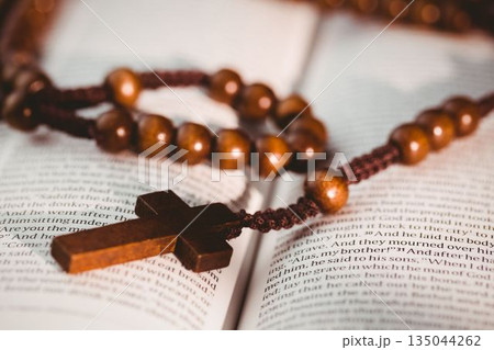 Rosary beads on open bible pages Rosary beads on open bible pages 135044262