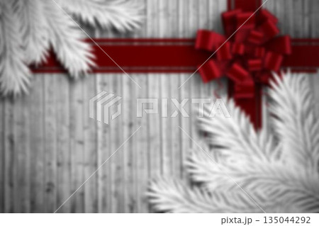 red bow is being displayed at satin ribbon cross on vertical wood planks with frosted pine red bow is being displayed at satin ribbon cross on vertical wood planks with frosted pine 135044292