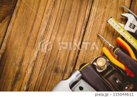 Vector flat lay is showing wrench tape and screwdrivers on wood grain copy space Vector flat lay is showing wrench tape and screwdrivers on wood grain copy space 135044611